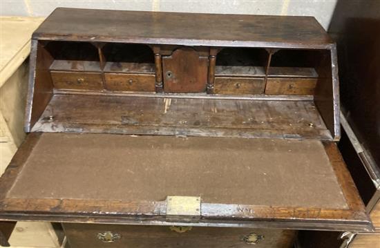 A mid 18th century oak bureau with well, width 92cm, depth 46cm, height 99cm